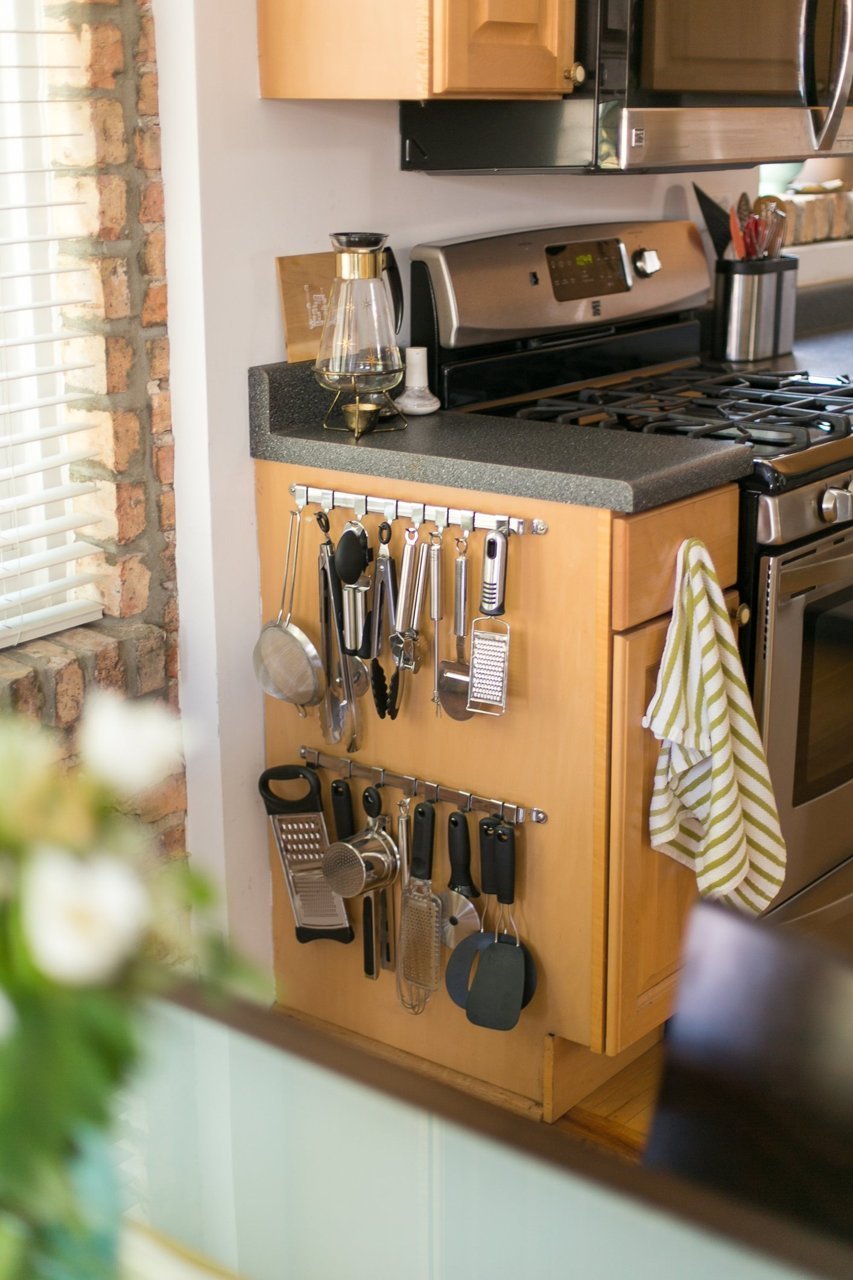 Attach Rack With Hooks to Outside of Cabinets For Utensils