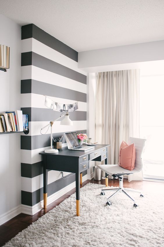 Awesome black and white stripe accent wall in a Hollywood regency style office--image via Style Me Pretty