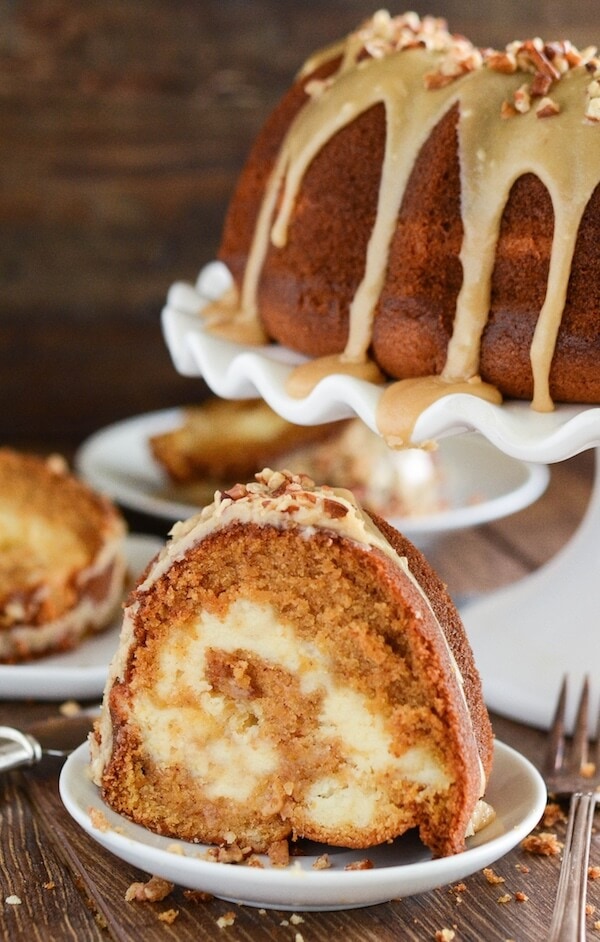 Sweet Potato Cream Cheese Bundt Cake with Praline Frosting! Looking for an impressive cake you can serve for dessert or breakfast? This rich, moist, sweet potato spiced cake is swirled with sweet cream cheese and topped with a pecan praline frosting.