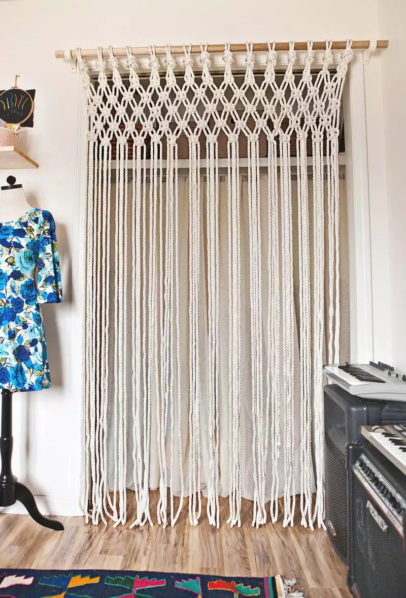A macrame curtain in front of a closet