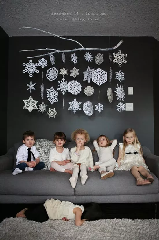 children under paper snowflakes