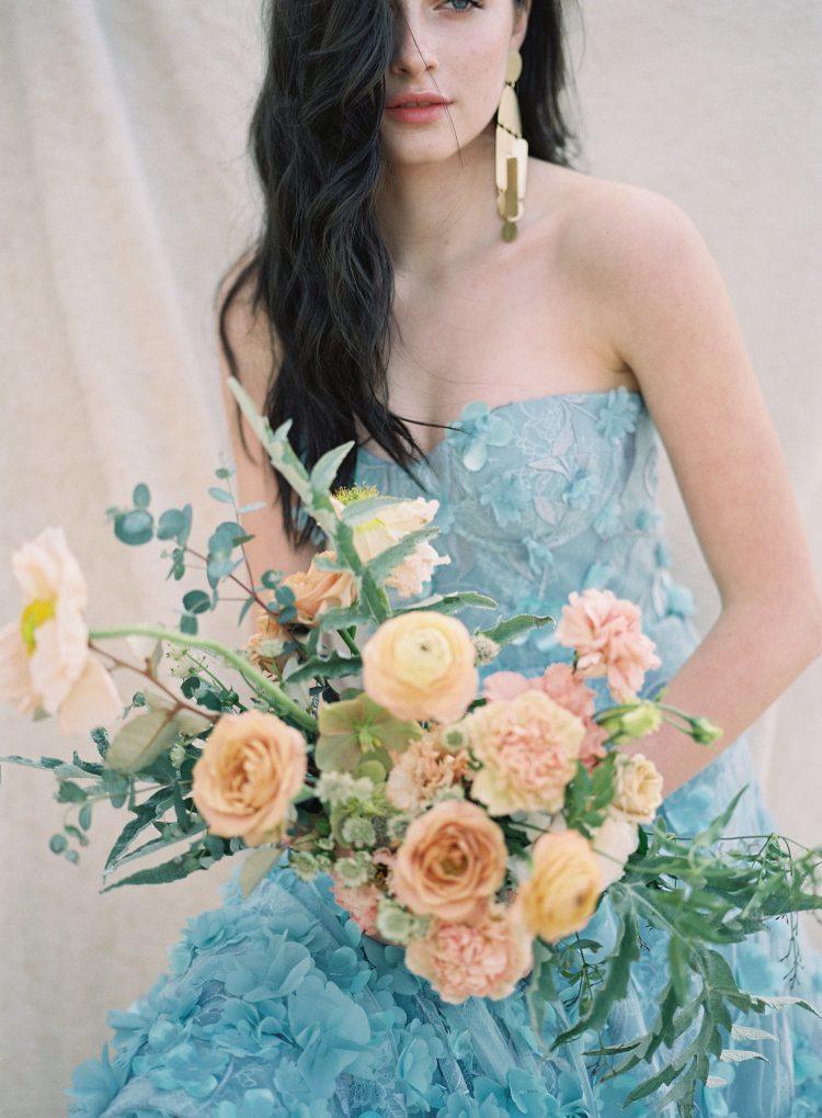 blue wedding dress with bridal bouquet 