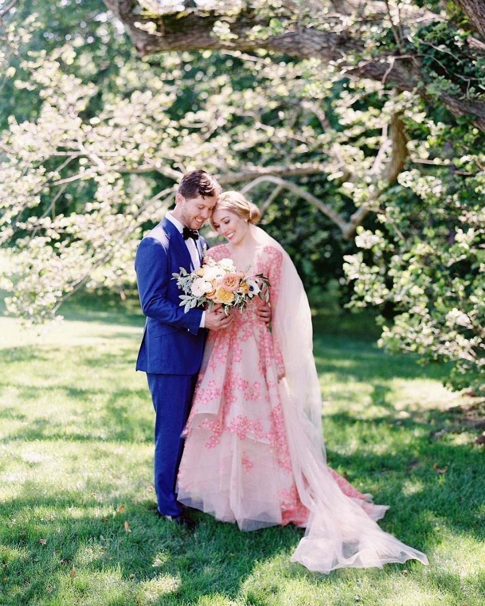 pink embroidered wedding dress with cobalt blue groom suit