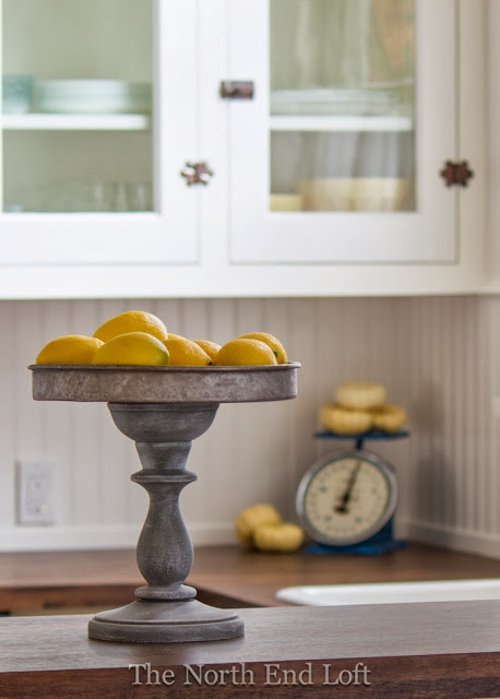 Love this DIY Rustic Pedestal then fill it with faux lemons for some easy and cute lemon home decor ideas!