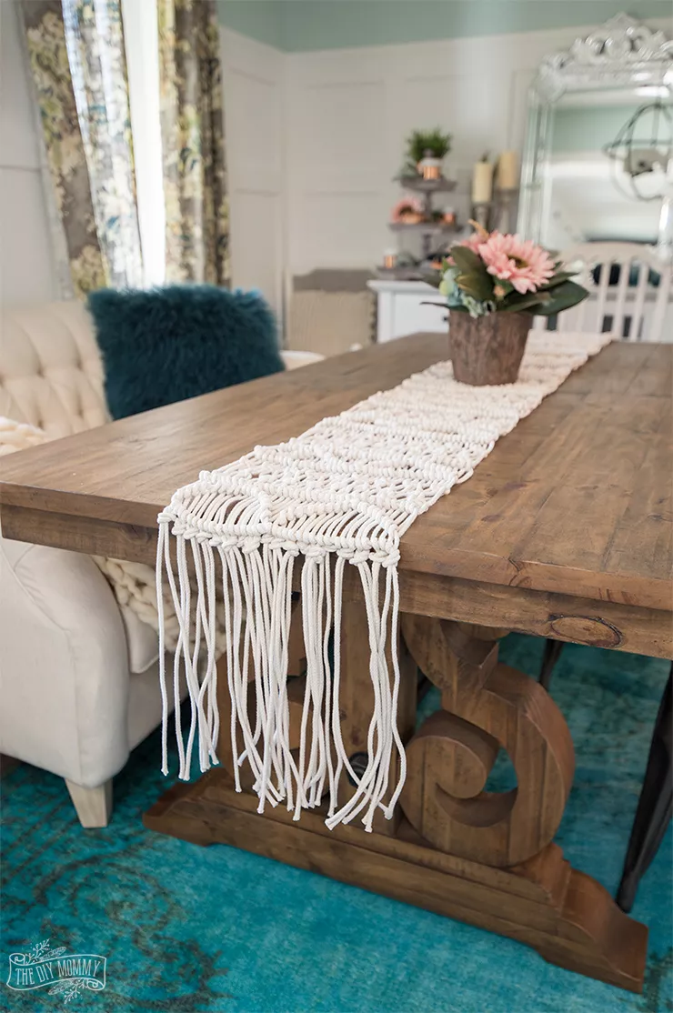 A macrame table runner on a dining room table