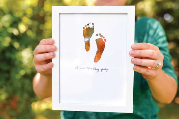 Adorable foiled footprint sign | 30 best handprint and footprint projects
