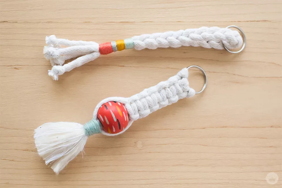 Two macrame key chains laying on a table