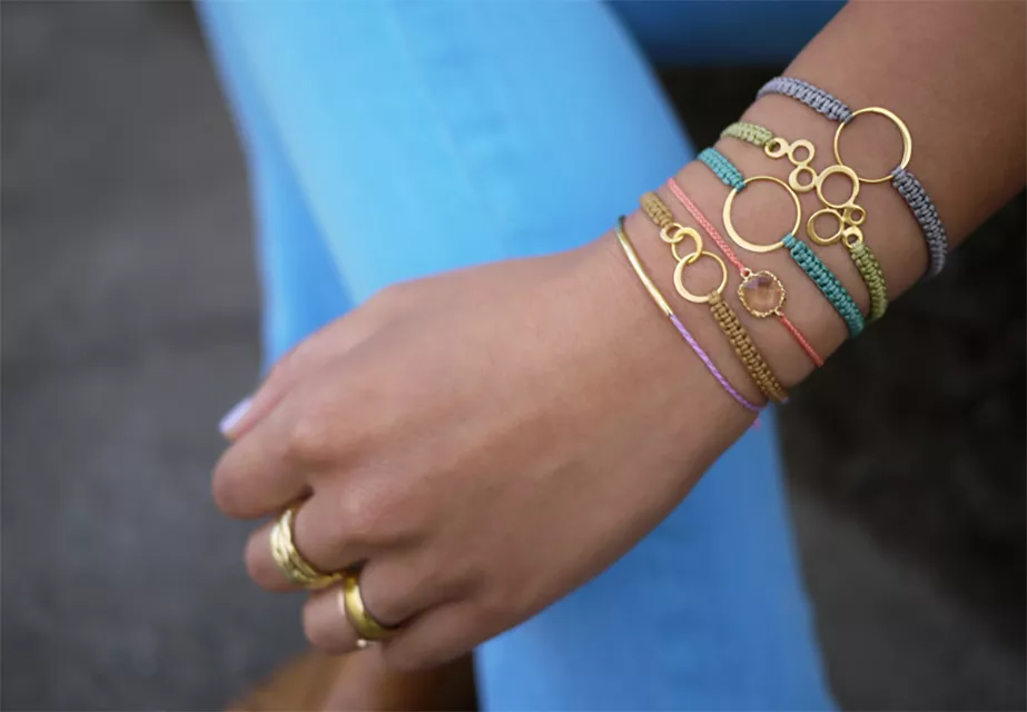 A woman wearing lots of macrame bracelets