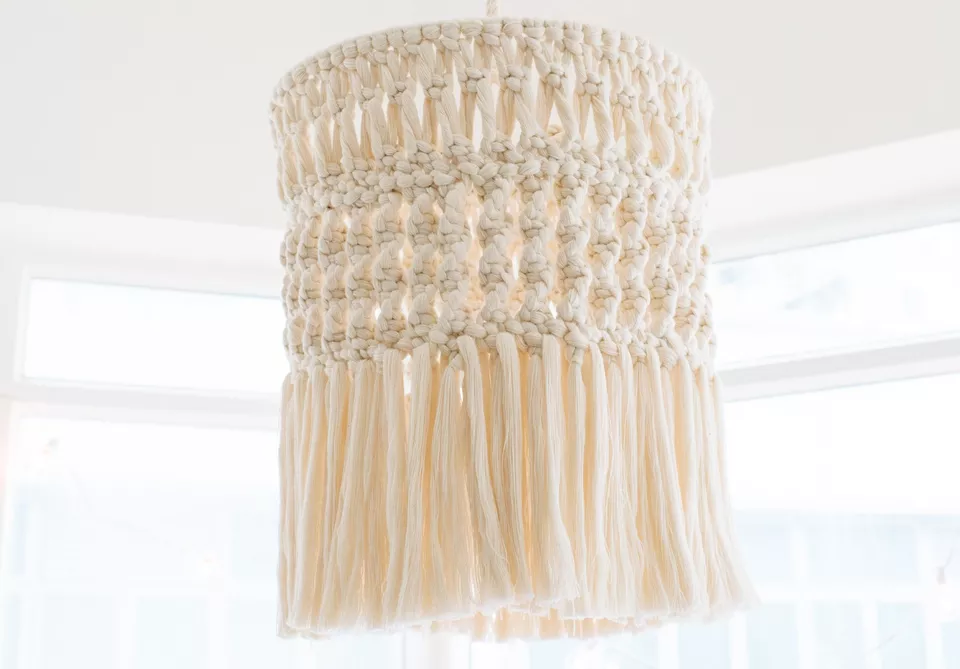 A macrame chandelier hanging from the ceiling