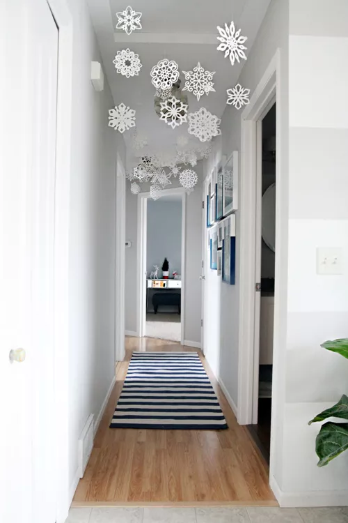 paper snowflakes hanging in a hallway